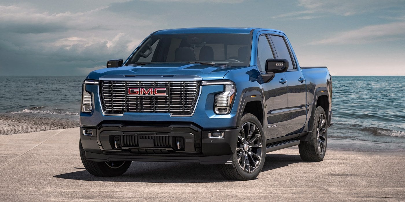 Blue GMC Sierra 1500 facing the camera on a beach road